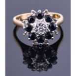 An 18ct yellow gold, diamond, and sapphire cluster ring the raised floral cluster set with eight