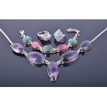 A silver and amethyst drop pendant necklace together with a silver, amethyst, and rhodalite garnet