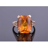 A 9ct yellow gold and citrine ring set with a rectangular faceted citrine in four claw setting, size