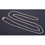 An early to mid 20th century white metal and pearl necklace the small pearl interspersed with