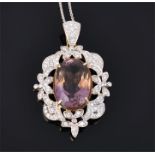 An 18ct yellow gold, diamond, and ametrine pendant set with a large oval cut ametrine within