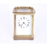 A small brass cased carriage clock with a white enamelled dial detailed with black numerals. Set