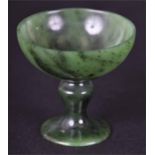 A miniature spinach green jade tazza possibly Chinese, 5.5 cm tall, bowl diameter 5.2 cm, together