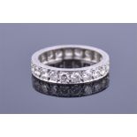 A platinum and diamond eternity ring set with twenty round cut diamonds of approximately 1.0 carat