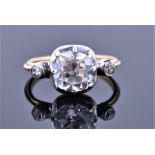 A yellow metal, silver, and cubic zirconia ring set with a large cushion cut cubic zirconia