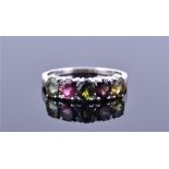 A 9ct white gold and tourmaline ring set with five oval cut tourmalines of various shades,