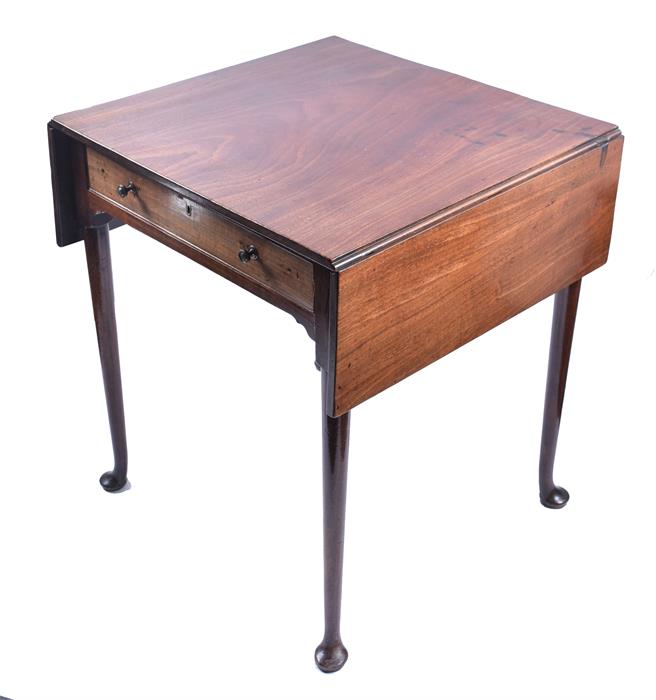 A George III mahogany drop-flap side table the top with a pair of hinged folding flaps, over a