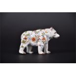An unusual French Faience or Desvres tin glaze bear in a standing pose, decorated with flowers and
