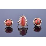 A Chinese yellow gold and coral ring set with an oval coral within geometric mount, size L 1/2,