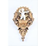 A large 19th century carved gilt wood and gesso cherub wall shelf the white painted cherub