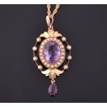 An Edwardian 15ct yellow gold, amethyst, and split seed pearl openwork pendant  set with an oval cut