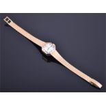 A 9ct yellow gold ladies Rotary wristwatch the octagonal white dial with Roman numerals. CONDITION