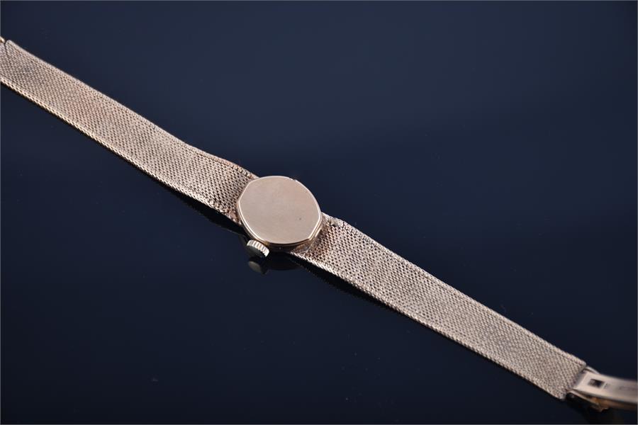 A ladies 9ct gold Rotary wristwatch with mechanical hand wound movement, on a bark effect mesh - Image 3 of 3