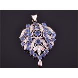 A white gold, diamond and blue sapphire pendant set with twenty-eight round cut blue sapphires