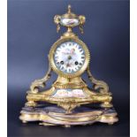 A 19th century French ormolu and painted porcelain mantel clock the drum shaped clock with painted