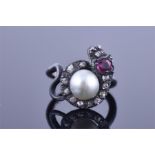 A handmade bespoke silver, diamond, ruby, and pearl ring in the form of a snake, the head inset with