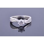 An 18ct white gold and solitaire diamond ring set with a round brilliant cut diamond of