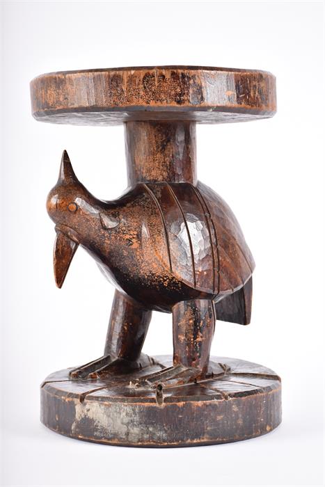 A late 19th / early 20th century carved tribal hardwood stool, possibly West African  with