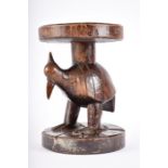 A late 19th / early 20th century carved tribal hardwood stool, possibly West African  with
