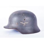 A Third Reich German Luftwaffe tin helmet decorated with the Reichsadler ('Imperial Eagle') and a