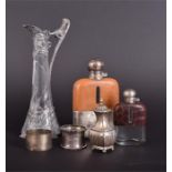 An Art Nouveau glass and pewter claret jug together with two hip flasks, one with silver top, a