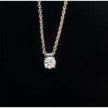 An 18ct white gold solitaire diamond pendant set with a round brilliant cut diamond of 0.28
