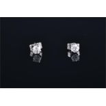 A pair of 14ct white gold and solitaire diamond ear studs the round brilliant cut diamonds of