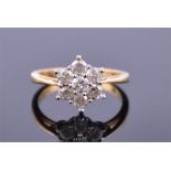 An 18ct yellow gold and diamond floral cluster ring set with seven round cut diamonds of