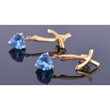 A pair of 14ct yellow gold and blue gemstone earrings each with a 'kiss' cross mount suspended