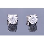 A pair of white gold solitaire diamond ear studs set with round brilliant cut diamonds of