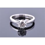 An 18ct white gold and solitaire diamond ring set with a round brilliant cut diamond of