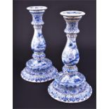 A pair of 19th century Delft candlesticks with tin glaze blue and white patterning, classical