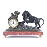 A large 19th Century French painted spelter mantel clock  the circular ceramic dial with Arabic