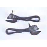 A pair of cast metal can openers both in the shape of a bull head, its tail to form the handle, 16.5