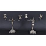 A pair of George V silver twin branch candelabra hallmarked Birmingham 1927, with embossed