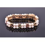 An 14ct yellow gold and pearl line bracelet set with clusters of four pearls around a central