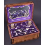 A good quality Victorian travelling vanity case in mixed veneers, the hinged lid with a vacant