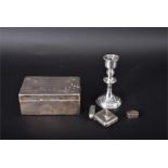 A collection of assorted silver including a silver cigarette box, a small silver candlestick, a