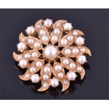 A yellow gold and pearl brooch of starburst design, decorated with split pearls, diameter 3cm