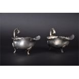 A pair of Edwardian silver sauceboats Birmingham 1902/3 by Finnigans Limited, with wavy rims and