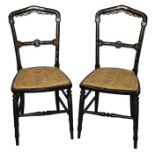 A pair of Victorian black lacquered and mother-of-pearl inlaid chairs the domed openwork backs