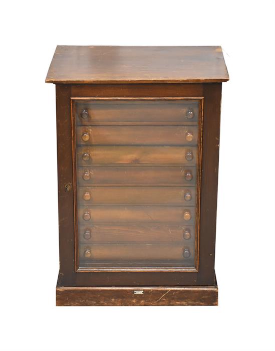 A small early 20th Century stained pine bank of ten collectors/display drawers  with turned handles,