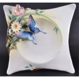 A Franz porcelain limited edition Papillon dish of square form with elongated corners, decorated