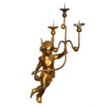 A 19th century cherub wall sconce formed as a winged cherub holding aloft a three light