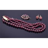 A garnet necklace of graduated beads fastened with a 14ct yellow gold clasp, together with a pair of