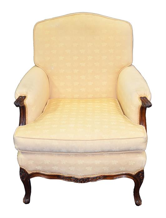 A Continental upholstered armchair with carved fruitwood frame, the back, sides and seat upholstered