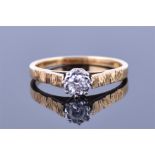 An 18ct yellow gold and solitaire diamond ring set with a round cut diamond of 0.25 carats, the