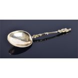A Continental silver gilt spoon, indecipherable mark, the stylised handle terminating with a soldier