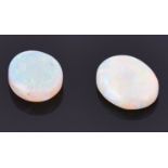 Two loose cabochon opals of oval form, one measuring 15 mm x 11 mm, the other 13 mm x 11 mm (2)