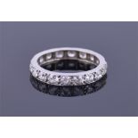 A diamond eternity ring set with eighteen round cut diamonds of approximately 0.90cts combined, with